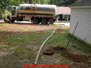 PHOTO of septic tank pumping vacuum hoses placed at the site