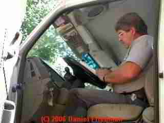 PHOTO of septic service operator recording septic cleaning
results and noting any unsafe conditions in writing before speaking with the owner.
