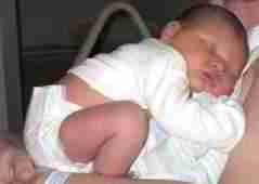 PHOTOGRAPH of
a really really cute baby wearing a newborn nappy that should NOT be flushed down the toilet.