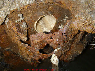 Steel septic tank baffle and tank rust damaged beyond repair (C) InspectApedia.com Transue