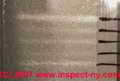 Photograph of parallel airborne particle traces on a microscope slide