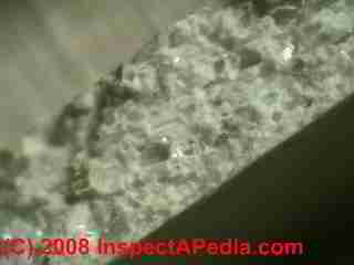 Edge view of broken asbestos containing floor tile