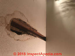 Leak and hole in plaster/lath wall - (C) InspectApedia.com Olivia