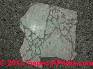 Presumed asbestos containing vinyl floor tile (C) InspectApedia