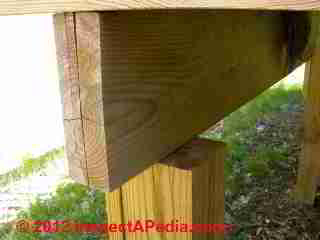 Improper deck framing - bad connection post to beam © D Friedman at InspectApedia.com 