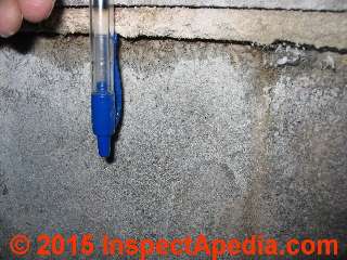 Photograph of frost push and horizontal overhang or sliding of sections of a masonry block wall. © Daniel Friedman at InspectApedia.com