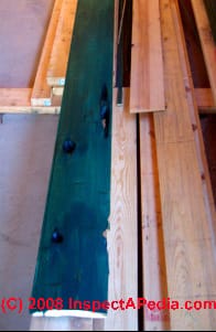 Log slab siding being stained