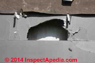 Gypsum board exterior wall sheathing under demolition © Daniel Friedman at InspectApedia.com
