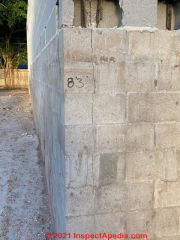 Vertical crack in concete block wall at corner  (C) InspectApedia.com  Don B