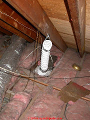 Bathroom vent dumping directly into attic risks moisture, insect damage, mold, rot damage and violates both manufacturers' instructions and building ventilation codes (C) Daniel Friedman at InspectApedia.com
