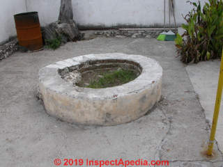 Hand dug well that has been filled in eliminates several safety and water contamination hazards (C) Daniel Friedman at InspectApedia.com