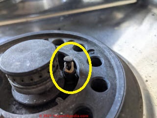 How to get out a stuck burner to replace broken porcelain gas burner igniter (C) InspectApedia.com Sudheer