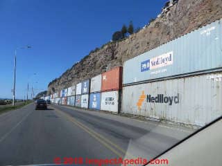 Shipping containers stacked as a safety-barrier / retaining wall, Sumner New Zealand 2014 (C) Daniel Friedman at InspectApedia.com