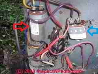 Starting capacitors in place on an air conditioning compressor (C) InspectAPedia.com
