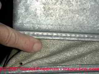 Photograph of asbestos fabric on an air conditioning and heating blower vibration damper