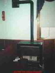 Photograph of a gas heater with possibly unsafe combustible clearances.