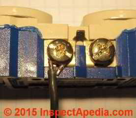 Binding head screw connector with copper wire on an electrical receptacle (C) Daniel Friedman