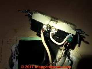 Ground wire connected to neutral wire on electrical receptacle (C) InspectApedia.com MS