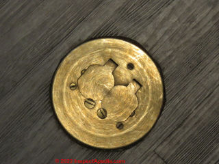 Round brass floor mounted electrical "outlet" (receptacle) in Niagara Falls NY (C) Daniel Friedman at InspectApedia.com