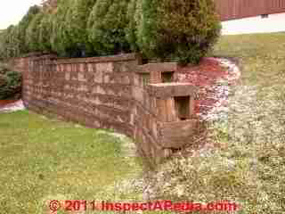 Retaining wall damage © D Friedman at InspectApedia.com 