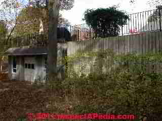 High retaining wall with guardrail © D Friedman at InspectApedia.com 