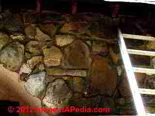 Stone veneer wall over wood frame - hidden leaks © D Friedman at InspectApedia.com 