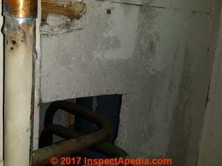 Asbestos suspect boiler room wall material in a U.K. closet (C) InspectApedia.com DC