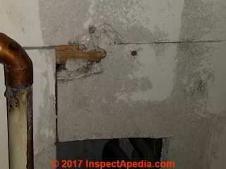 Asbestos suspect boiler room wall material in a U.K. closet (C) InspectApedia.com DC