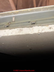 Drop ceiling tiles, asbestos suspect  - whitish gray material (C) InspectApedia.com Joe