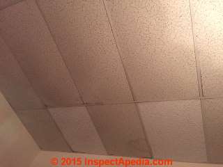 Suspended ceiling tiles that may contain asbestos (C) InspectApedia.com reader