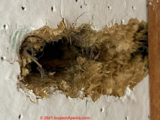 Tan woody fibre ceiling tiles probably not asbestos (C) InspectApedia.com Anika
