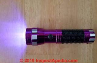 Handheld UV flashlight suitable for small investigations (C) Daniel Friedman at InspectApedia.com