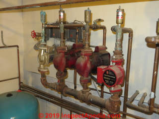 Air eliminators installed at each heating zone near the return to the boiler (C) InspectApedia.com Daniel Friedman