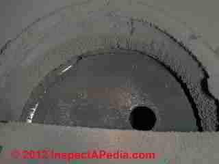 Oil burner soot inside heater © D Friedman at InspectApedia.com 