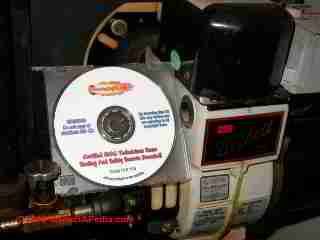 Photograph of  our oil fired heating boiler with Mikes CD book on how to save heating costs
