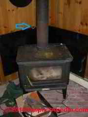 Wood stove showing manual flue damper (C) Daniel Friedman