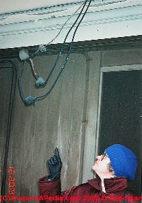 Dangerous electrical wires overhead by house door