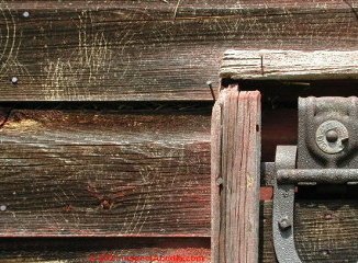 Raccoon scratches on the wood siding of this antique barn are good evidence of their activity even if you don't see them personally (C) DanieL Friedman at InspectApedia.com