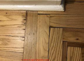 gaps and stains in wood parquet flooring (C) InspectApedia.com Mgever
