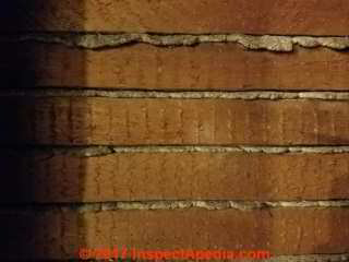 Vertical saw kerf marks on wood lath plaster wall © Daniel Friedman at InspectApedia.com