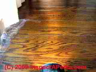 Solid oak flooring, cupped -(C) Daniel Friedman at InspectApedia.com