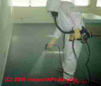 Spraying a biocide at a mold remediation project © Daniel Friedman at InspectApedia.com