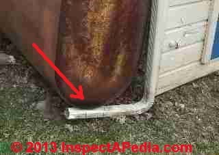 Outdoor above ground oil tank with leak stains at tank bottom (C) Daniel Friedman