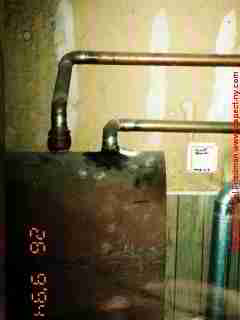 Copper oil tank fill vent seepage © D Friedman at InspectApedia.com 