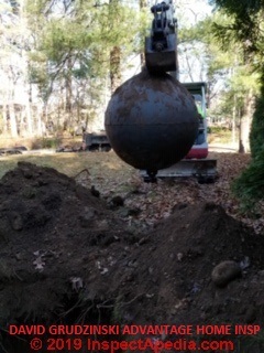 Spherical oil tank being removed from buried site (C) InspectApedia.com David Grudzinski Advantage Home Inspections