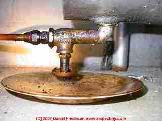 Photograph of a small heating oil leak at a tank fire-o-matic safety valve at the tank bottom