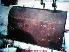 Photograph of an above ground oil tank which may be in serious trouble.