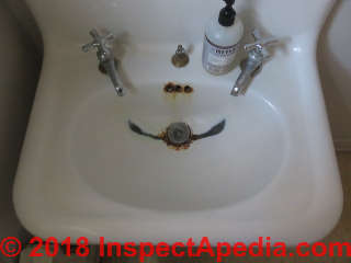 Badly corroded sink, prolonged faucet leakage (C) Daniel Friedman at InspectApedia.com