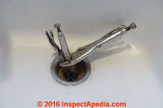 Using a pair of Vise Grip locking pliers to grab the slipping sink strainer assembly from above (C) InspectApedia.com Daniel Friedman