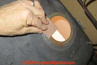 Sandpaper to remove heavy rust on the sink drain opening underside (C) Daniel Friedman